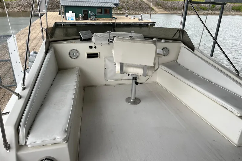 Slide: The Image of Upper deck of a 1995 WaveLenth Wide Body boat with seating and controls. - 34