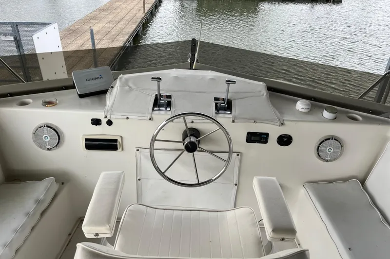 Slide: The Image of Cockpit of 1995 WaveLenth Wide Body boat with steering wheel and Garmin device. - 35