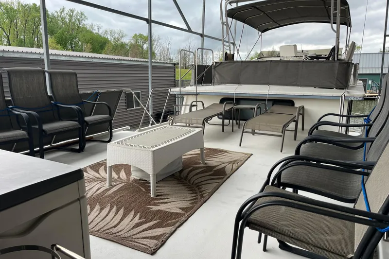 Slide: The Image of Spacious deck of 1995 WaveLenth Wide Body boat with seating and table. - 38