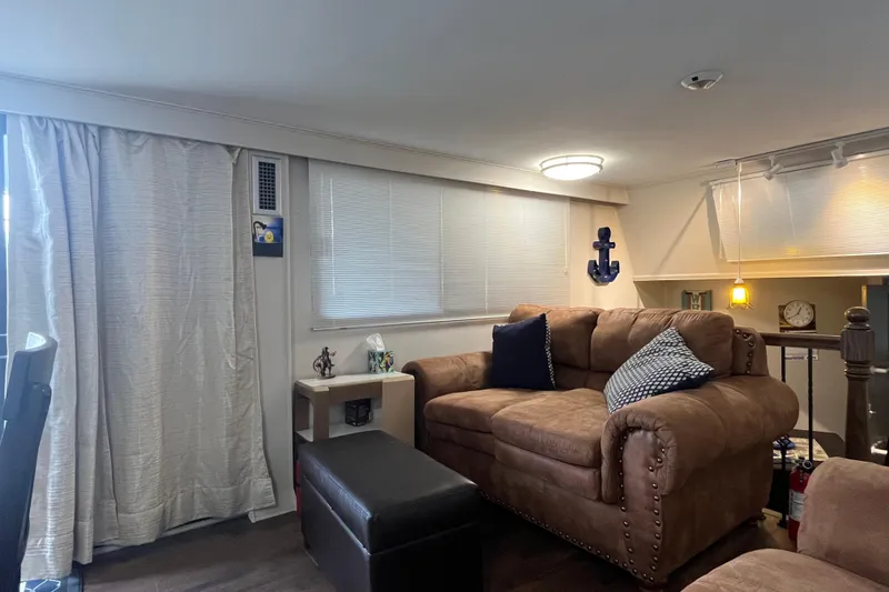 Slide: The Image of Cozy living area in 1995 WaveLenth Wide Body with brown sofa and nautical decor. - 4