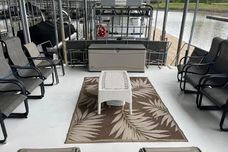 Slide: The Image of Spacious 1995 WaveLenth Wide Body boat deck with seating and patterned rug. - 40