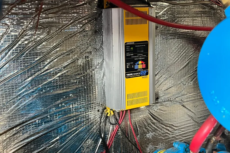 Slide: The Image of Battery charger in a 1995 WaveLenth Wide Body, surrounded by reflective insulation. - 45