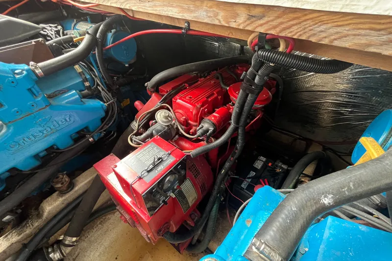 Slide: The Image of Engine compartment of a 1995 WaveLenth Wide Body boat with red and blue components. - 46