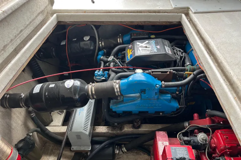 Slide: The Image of Engine compartment of a 1995 WaveLenth Wide Body boat, featuring a Crusader engine. - 49
