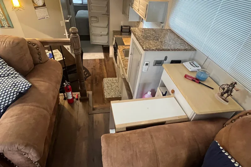 Slide: The Image of Interior of a 1995 WaveLenth Wide Body RV with kitchen and living area. - 5
