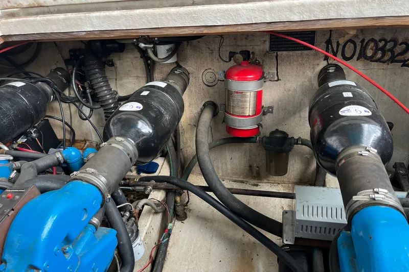 Slide: The Image of Engine compartment of a 1995 WaveLenth Wide Body boat with visible components and fire extinguisher. - 52