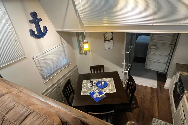 Slide: The Image of Cozy dining area in 1995 WaveLenth Wide Body RV with nautical decor. - 6