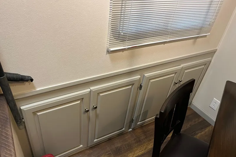 Slide: The Image of Cabinet doors beneath window blinds in a 1995 WaveLenth Wide Body interior. - 9