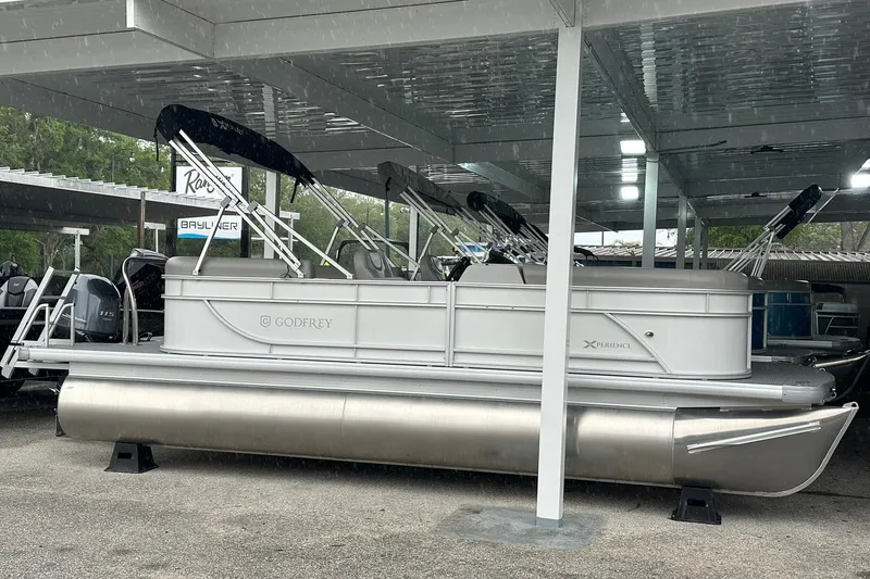 The Image of Pontoon boat under shelter, Sweetwater EX2086S model, 2026, with sleek design and canopy. - 1