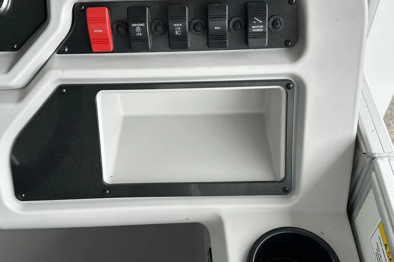Slide: The Image of Control panel of 2026 Sweetwater EX2086S boat with switches and storage compartment. - 12