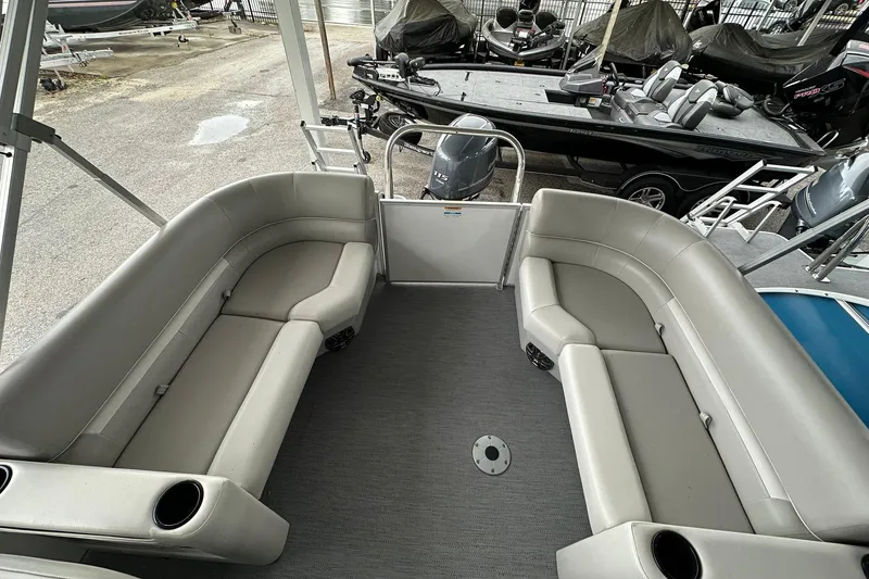 Slide: The Image of 2026 Sweetwater EX2086S pontoon boat interior with gray seating and cup holders. - 16