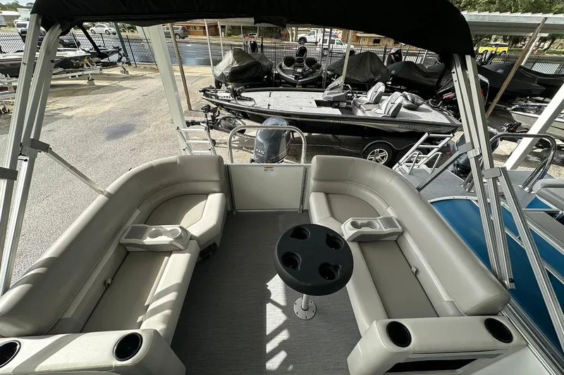 Slide: The Image of 2026 Sweetwater EX2086S pontoon boat interior with seating and cup holders. - 21