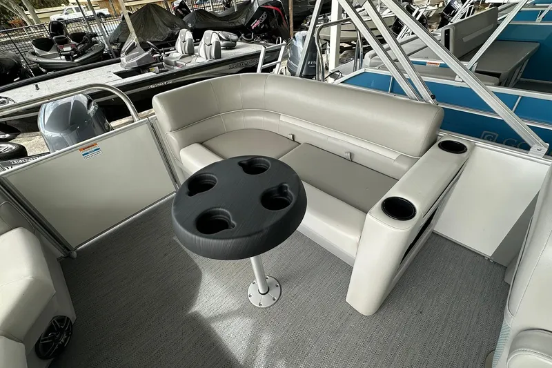 Slide: The Image of Interior of 2026 Sweetwater EX2086S pontoon boat with seating and cup holders. - 22