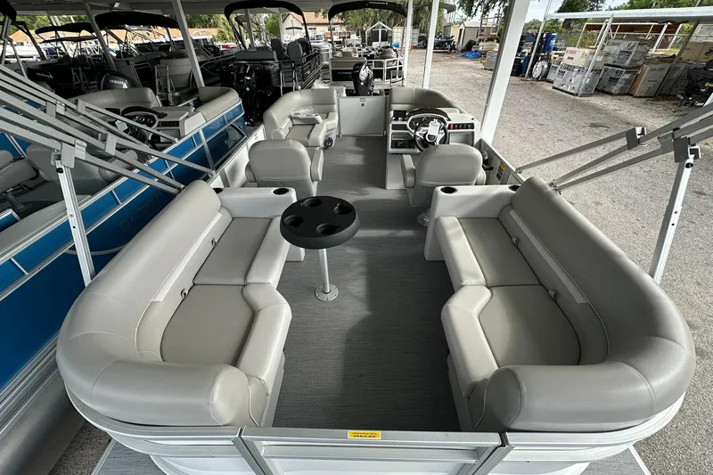 Slide: The Image of 2026 Sweetwater EX2086S pontoon boat interior with gray seating and steering console. - 23