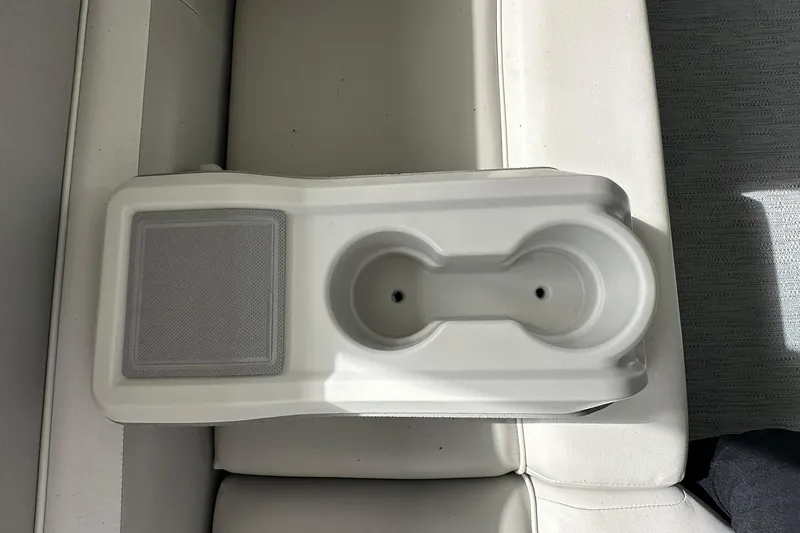 Slide: The Image of Sweetwater EX2086S 2026 boat cup holder and speaker on white seating. - 24