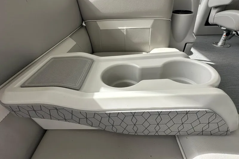 Slide: The Image of 2026 Sweetwater EX2086S boat interior with dual cup holders and textured armrest. - 25