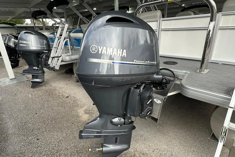 Slide: The Image of Outboard motor on a Sweetwater EX2086S boat, 2026 model, displayed in a showroom. - 28