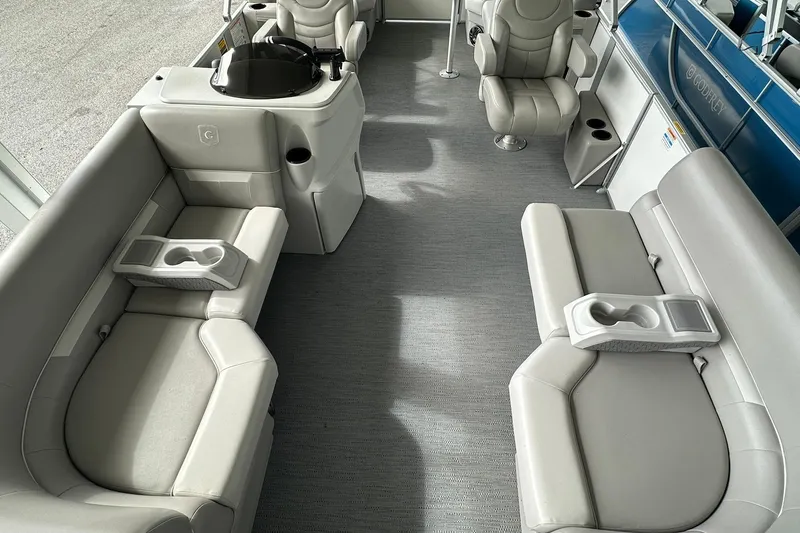 Slide: The Image of Luxurious interior of 2026 Sweetwater EX2086S pontoon boat with plush seating and cup holders. - 7