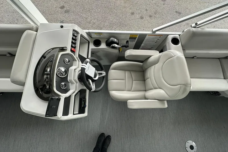 Slide: The Image of Interior view of 2026 Sweetwater EX2086S boat with steering console and captain's chair. - 9