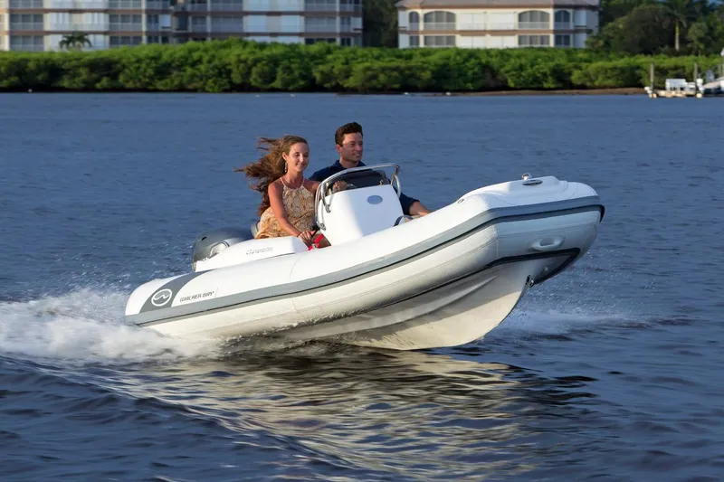 Slide: The Image of Manufacturer Provided Image: 2025 Walker Bay Generation 360 DLX boat speeding on water with two passengers. - 1