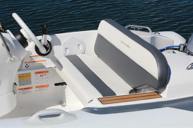 Slide: The Image of Manufacturer Provided Image: 2025 Walker Bay Generation 360 DLX boat interior with gray seating and steering wheel. - 10