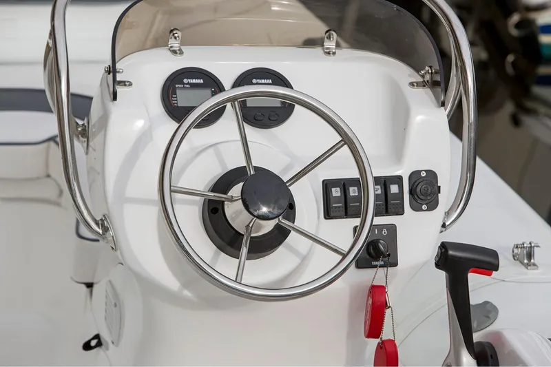 Slide: The Image of Manufacturer Provided Image: 2025 Walker Bay Generation 360 DLX boat dashboard with steering wheel and controls. - 11