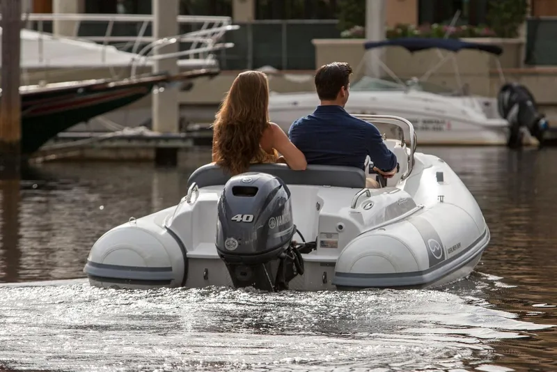 Slide: The Image of Manufacturer Provided Image: Couple cruising on 2025 Walker Bay Generation 360 DLX boat in marina. - 3
