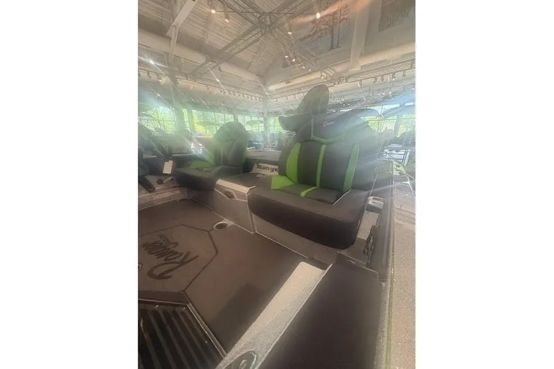 Slide: The Image of 2026 Ranger Z519R boat interior with green and black seating in a showroom. - 4