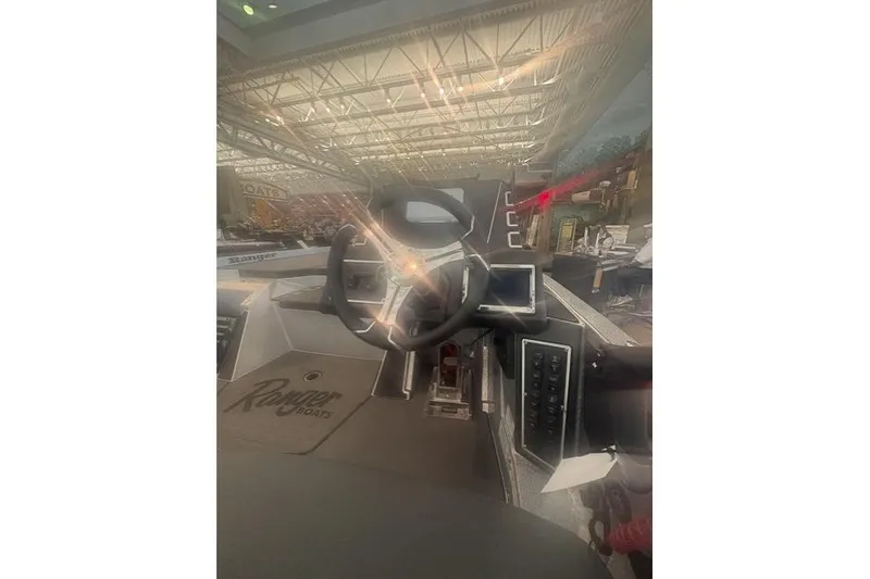 Slide: The Image of 2026 Ranger Z519R boat dashboard with steering wheel and control panel in showroom. - 5
