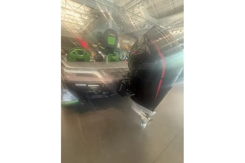 Slide: The Image of 2026 Ranger Z519R boat with powerful outboard motor in showroom setting. - 7