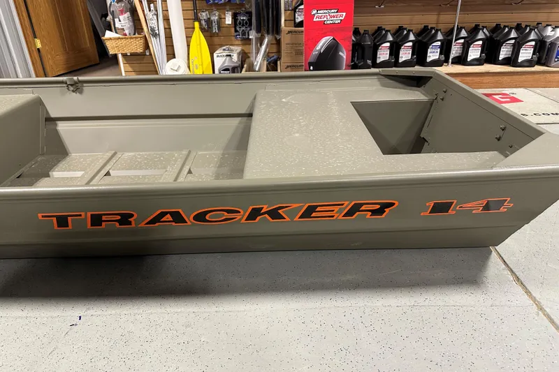 Slide: The Image of 2026 Tracker Grizzly 14 Jon boat displayed in a showroom setting. - 55