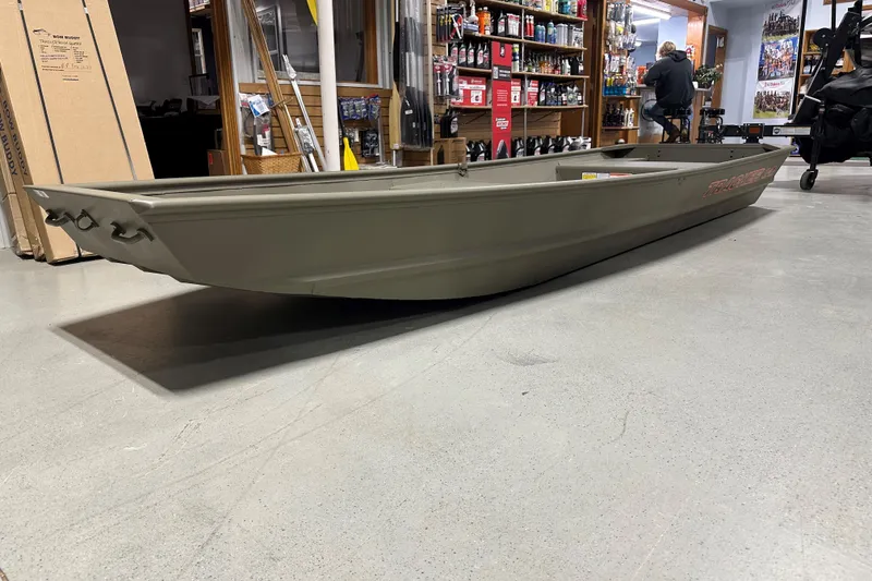 Slide: The Image of 2026 Tracker Grizzly 14 Jon boat displayed indoors, showcasing its sleek design and sturdy build. - 59