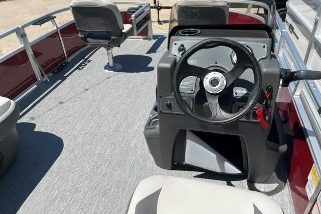 Slide: The Image of 2026 Sun Tracker Bass Buggy 16 XL Select pontoon boat interior with steering console. - 2