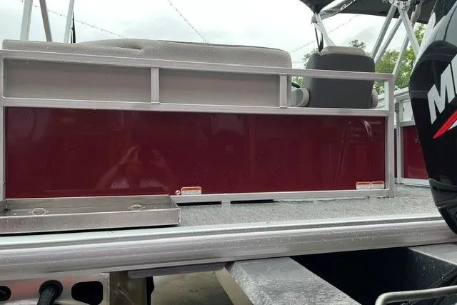 Slide: The Image of 2026 Sun Tracker Bass Buggy 16 XL Select pontoon boat, rear view with maroon paneling. - 3