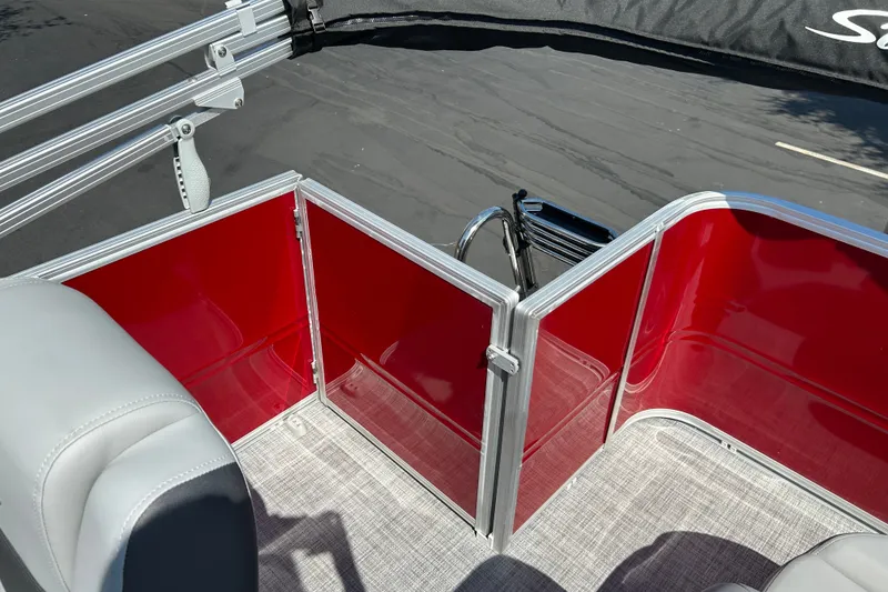 Slide: The Image of 2026 Sun Tracker Party Barge 18 DLX interior with red panels and gray seating. - 17