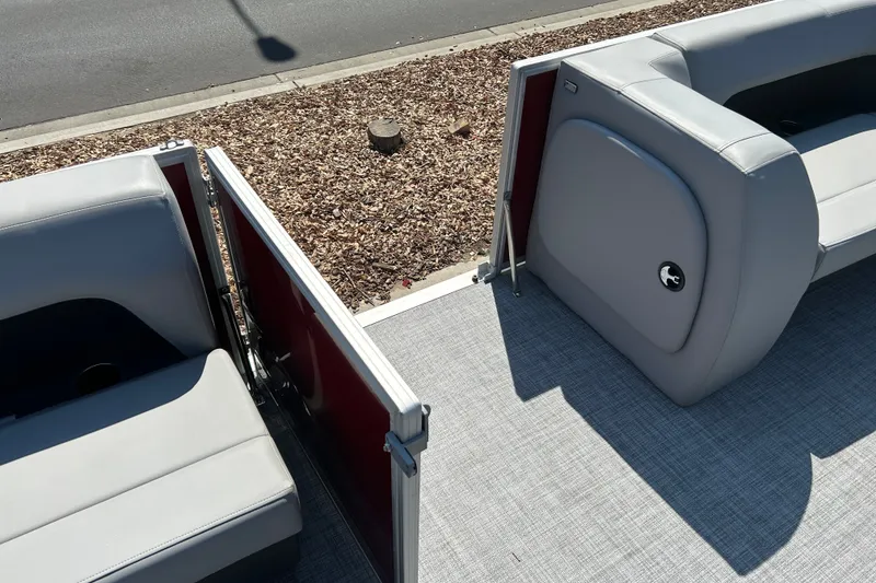 Slide: The Image of 2026 Sun Tracker Party Barge 18 DLX interior with gray seating and open gate. - 21
