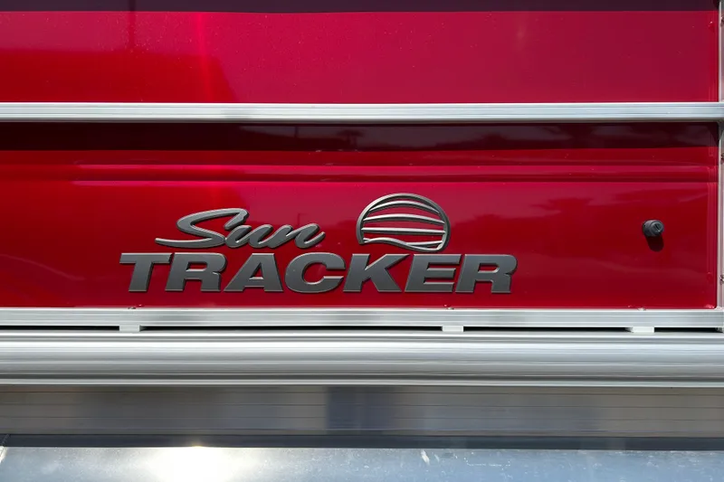 Slide: The Image of 2026 Sun Tracker Party Barge 18 DLX logo on red background. - 23