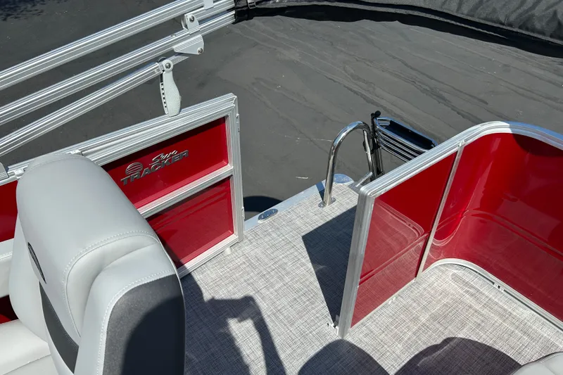 Slide: The Image of 2026 Sun Tracker Party Barge 18 DLX interior with red panels and seating. - 16