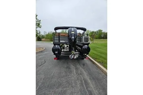 Slide: The Image of 2026 Ranger 220FC boat on a paved road, rear view with outboard motor. - 60