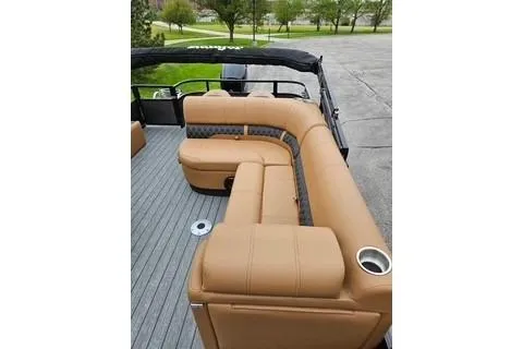 Slide: The Image of 2026 Ranger 220FC boat interior with tan seating and cup holders. - 63