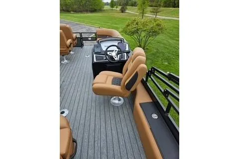Slide: The Image of 2026 Ranger 220FC boat interior with tan seating and modern dashboard. - 65