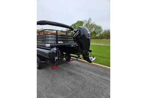 Slide: The Image of 2026 Ranger 220FC boat with powerful outboard motor on a trailer. - 68