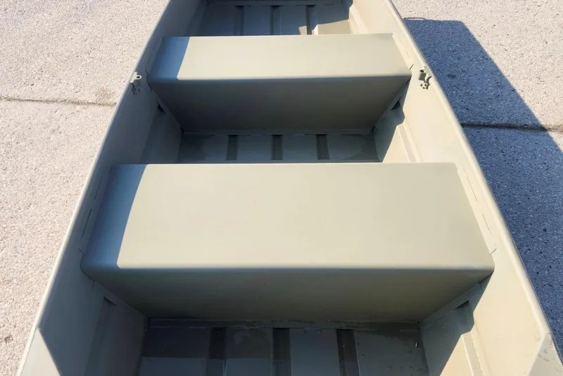 The Image of 2026 Tracker Grizzly 10 Jon boat interior with bench seats, shown on concrete surface. - 0