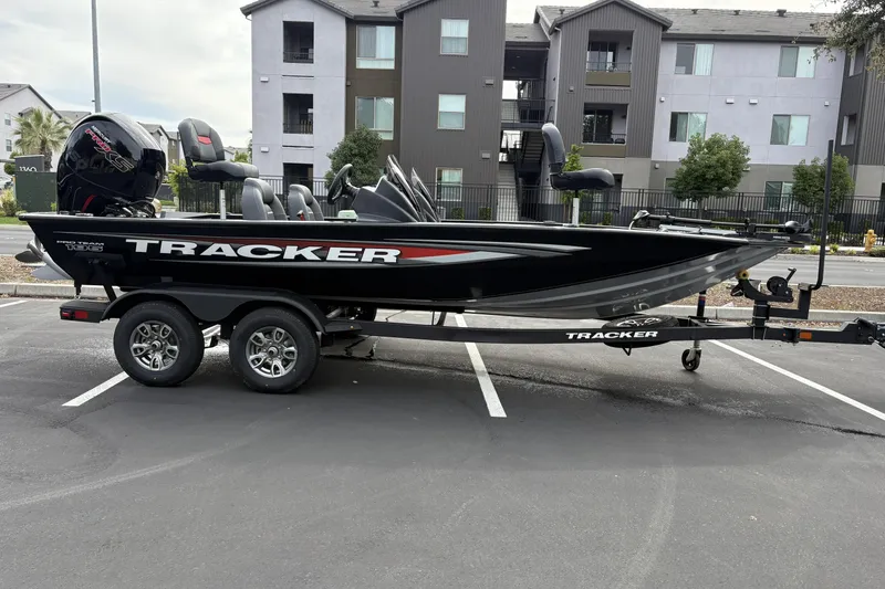 The Image of 2026 Tracker Pro Team 195 boat on trailer in parking lot. - 0