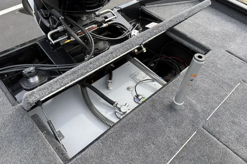 Slide: The Image of Open compartment of 2026 Tracker Pro Team 195 boat showing engine and wiring. - 10