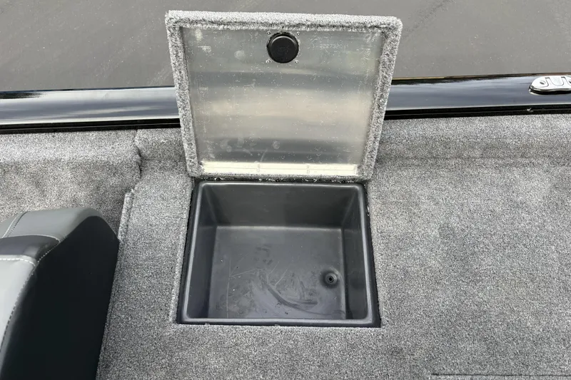 Slide: The Image of Open storage compartment on 2026 Tracker Pro Team 195 boat, featuring carpeted interior. - 5