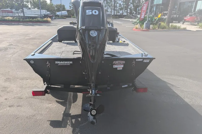 Slide: The Image of 2026 Tracker Bass Tracker Classic XL boat with Mercury 50 engine, parked outdoors. - 5