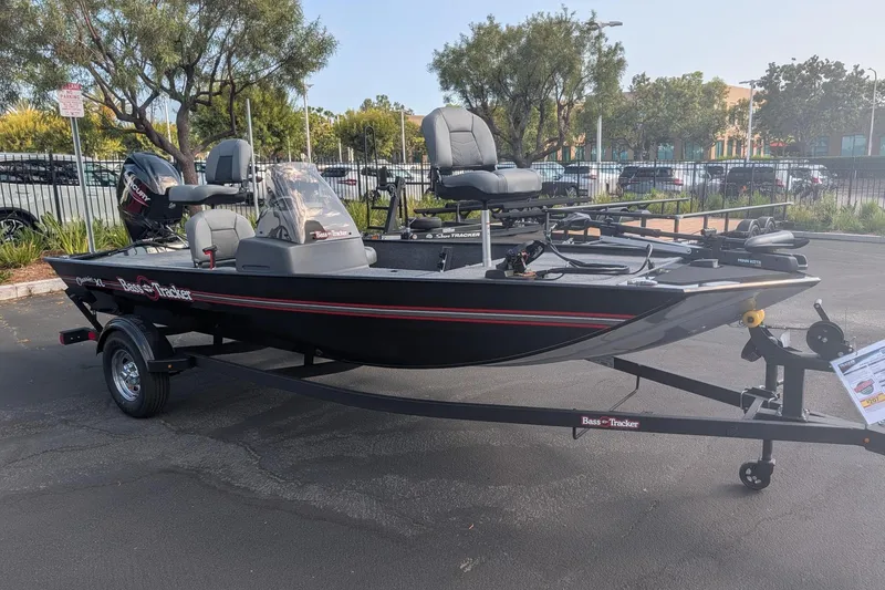 Slide: The Image of 2026 Tracker Bass Tracker Classic XL boat on trailer in parking lot. - 2