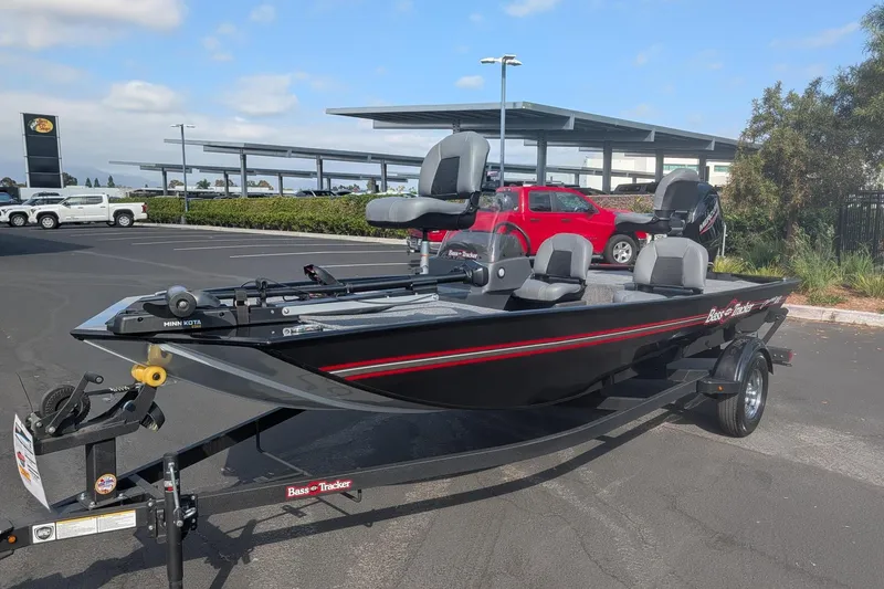 Slide: The Image of 2026 Tracker Bass Tracker Classic XL fishing boat on trailer in parking lot. - 3