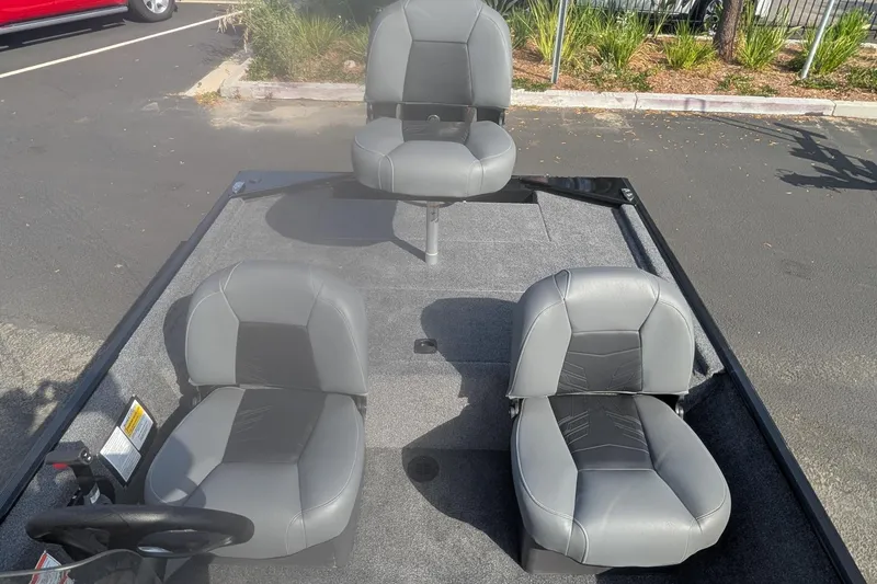Slide: The Image of 2026 Tracker Bass Tracker Classic XL boat interior with three gray seats. - 10